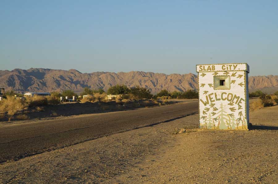 A handpainted welcome sign marks Slab City limits.